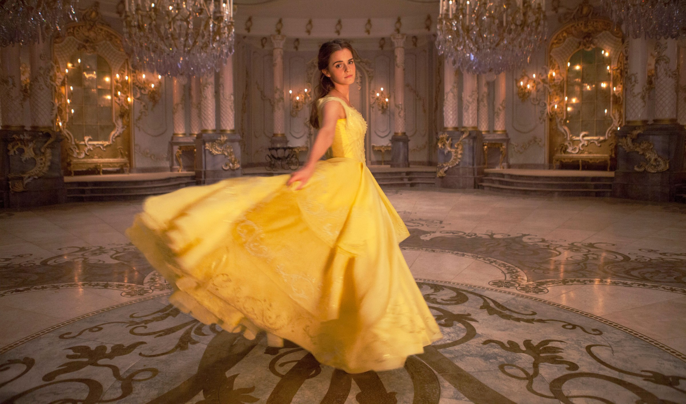 Emma Watson twirling in a yellow gown in Disney’s live-action Beauty and the Beast