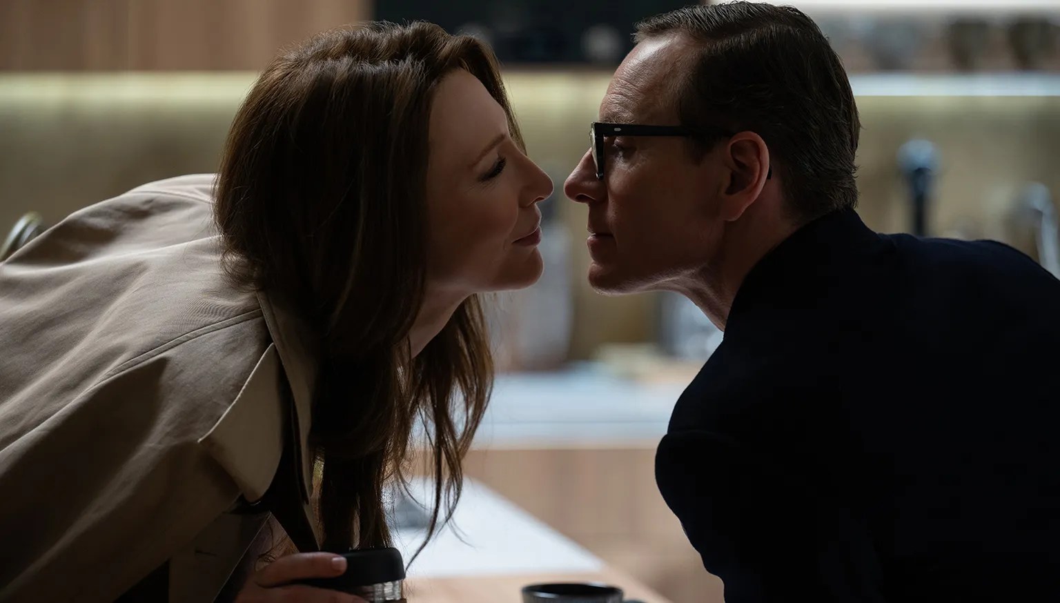 Cate Blanchett and Michael Fassbender leaning in for a kiss in Black Bag.