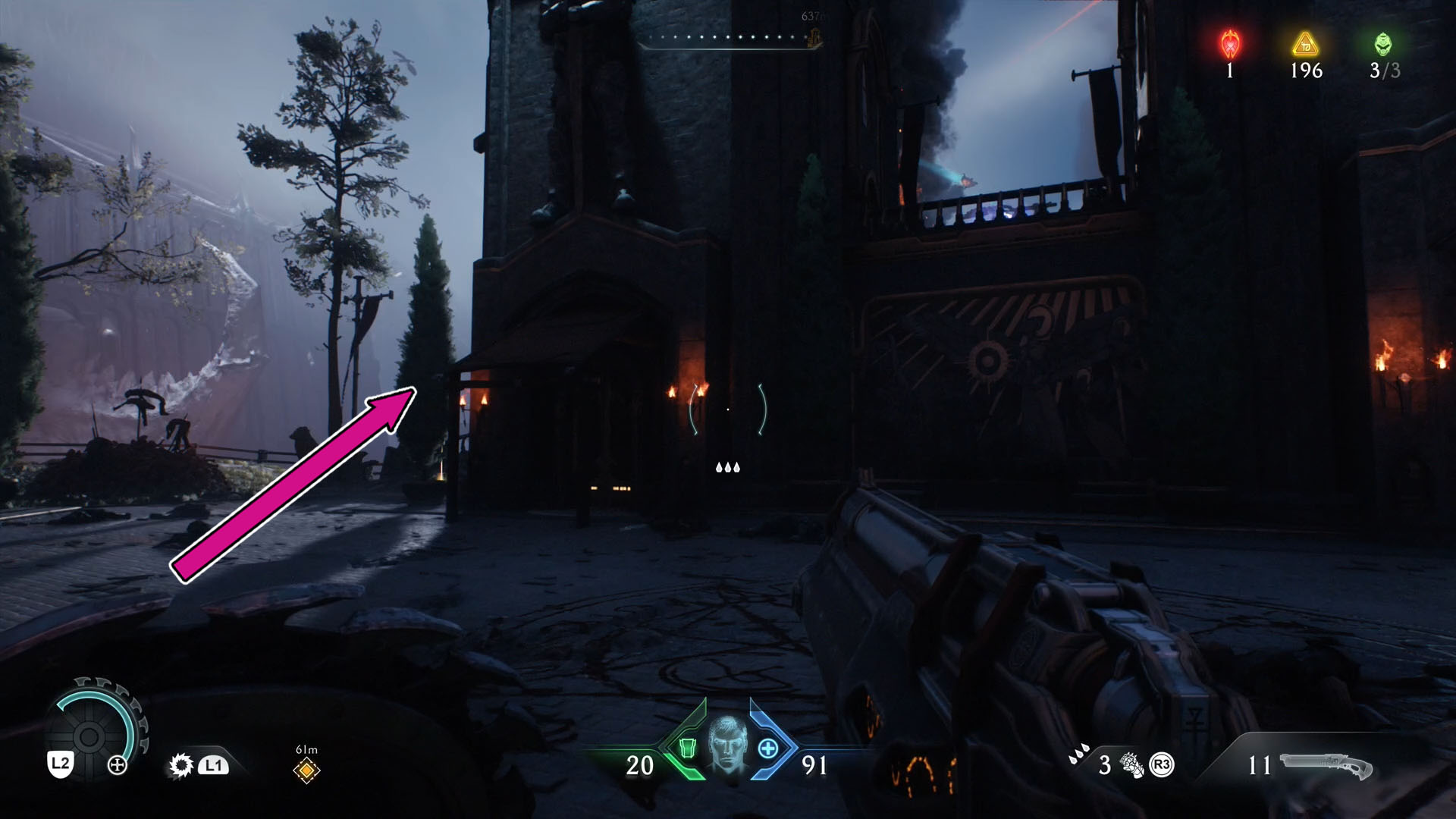 A Doom: The Dark Ages screenshot showing part of a building with a statue on one of its toweres. A pink arrow indicates to follow the path to the left.