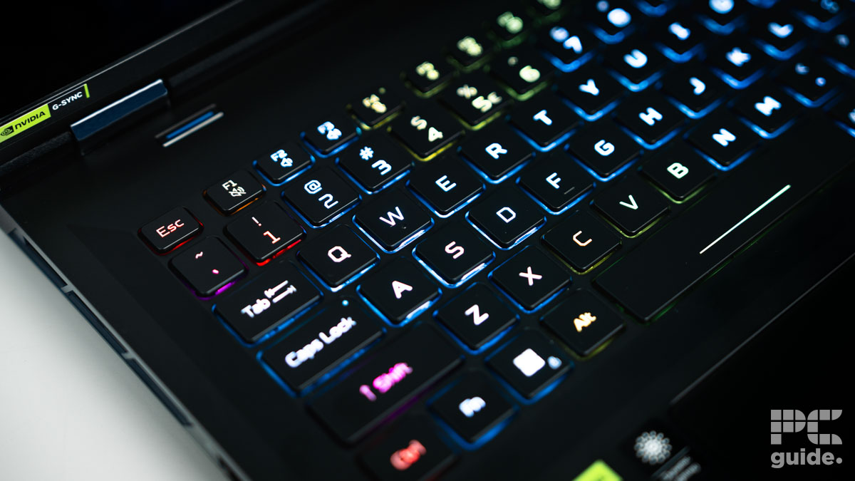 A closses up of the laptop's keyboard. Zoomed in on the WASD keys with a black colorway but RGB lighting up each of the keys.